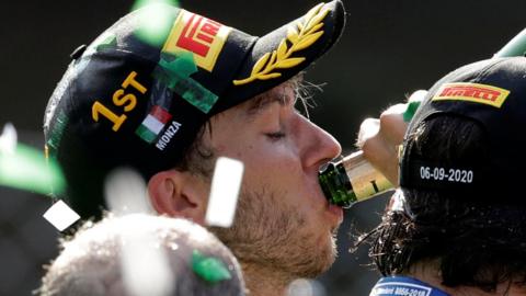 Pierre Gasly drinks champagne