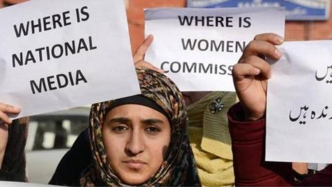 Activists holding placards during a protest against the rape and murder a Kathua child, at Lal Chowk in Srinagar.