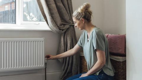 Woman by radiator