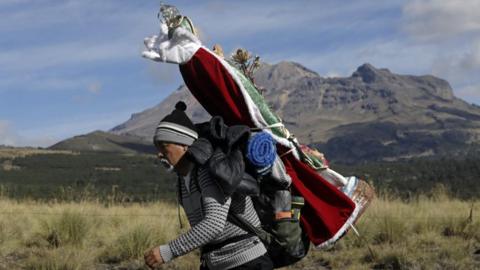 A man walks towards the Basilica of Guadalupe in the Paso de Cortes area in the state of Puebla, Mexico, 09 December 2023.