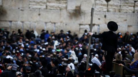 A crowd of religious Jews attend a special prayer for rain at the Western Wall in Jerusalem"s Old City, December 28, 2017