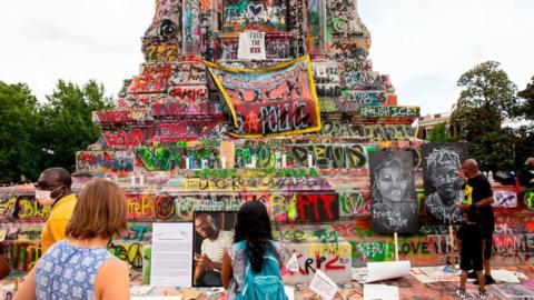 Colourful graffiti now adorns the plinth supporting Robert E Lee's statue in Richmond