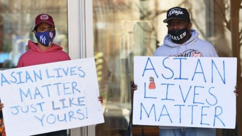 Two people holding Asian Lives Matter signs in US