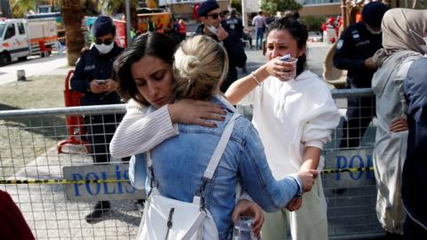 People react as rescue operations continue after an earthquake in the Aegean port city of Izmir, Turkey, 1 November, 2020.