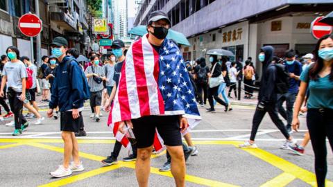 One Hong Kong protester is draped with the US flag during the 24th May 2020 protests.