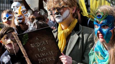 Extinction Rebellion protestors pose outside Government Buildings in Dublin