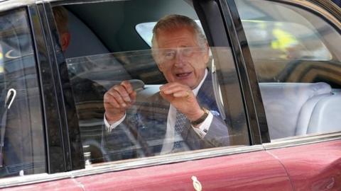 King Charles rides in the back of a car to Buckingham Palace ahead of the Coronation