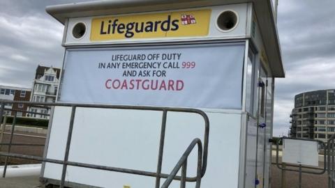 The lifeguard provision on Bexhill beach with a 'Lifeguard off duty' sign on the front