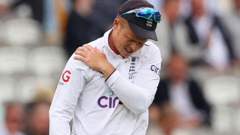 Ollie Pope holds his right shoulder after dislocating it in the second Ashes Test at Lord's