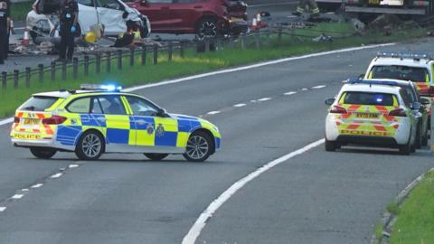 Police cars and wreckage on the A1 (M) following the crash