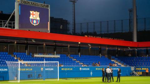 The referees talk on the field at Johan Cruyff Stadium after the first day of Liga F 23-24 was suspended because of the strike