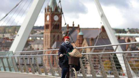 Person on bike on Peace Bridge in Derry