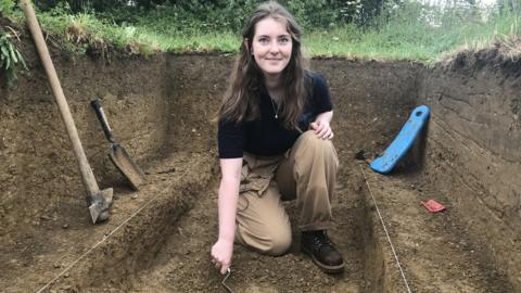 Archaeologist Indie Jago in a trench at Kelmscott