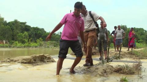 People wading through water