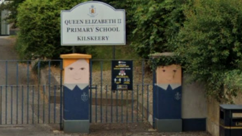 The entrance to Queen Elizabeth II School in Kilskeery, with gate pillars painted to look like school pupils