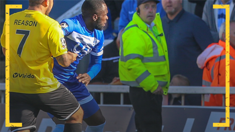 Jai Reason of Dover Athletic holds back Hartlepool United's Gus Mafuta following abuse from the crowd