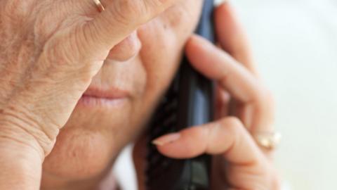 stock image of an elderly person on the phone