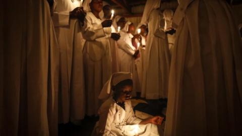 Members of the Legio Maria hold a vigil at their church in Nairobi, Kenya.