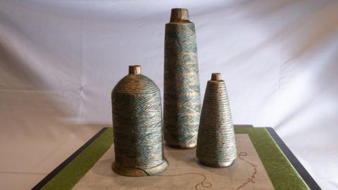 Artwork of three bell shaped forms.