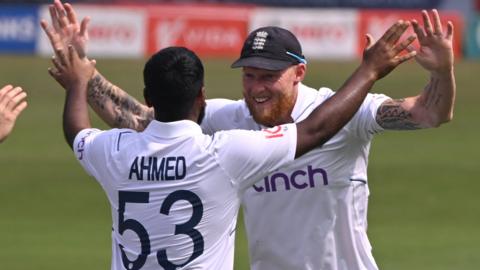 Rehan Ahmed celebrates with Ben Stokes