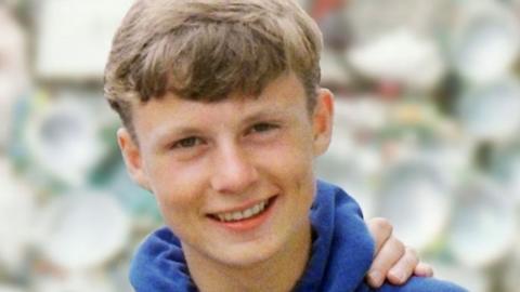 Image of Lee Boxell aged 15, with light brown hair wearing a blue hooded top.