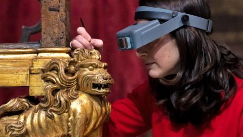 Conservator Krista Blessley works on the restoration of a Coronation chair, at Westminster Abbey in London