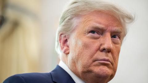 US President Donald Trump looks on during a ceremony at the White House in Washington, DC on December 7, 2020.