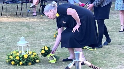 Woman laying flowers