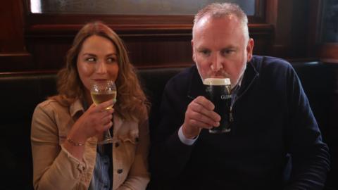 Natalie Knox and Campbell Brady enjoy a rink at The Garrick Bar in Belfast after the latest easing of lockdown restrictions in Northern Ireland