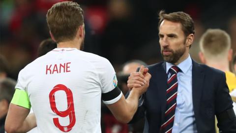 England captain Harry Kane (left) and manager Gareth Southgate (right) shake hands after a match