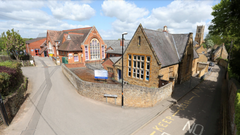 Stone-built village primary school at road junction