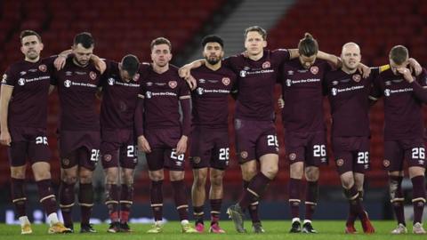 Hearts team watching the penalty shoot-out