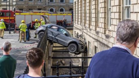 Bath car crashes through railings