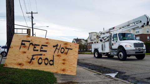 A handmade sign offering free hot food is seen in front of the Royal Tandoor restaurant after Hurricane Laura passed through the area in Lake Charles, Louisiana,