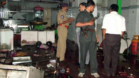 Police inspect the interior after the blast at Gokul Chat in Hyderabad