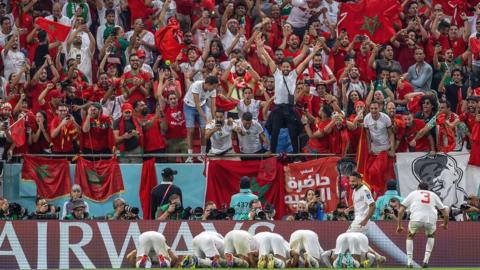 Morocco players pray in front of fans