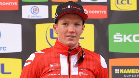 Soren Kragh Andersen smiles on the podium after winning stage four of Paris-Nice