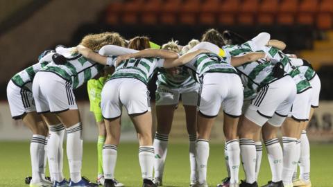Celtic women's players gather in a huddle