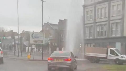 Car driving past jets of water in Woolwich