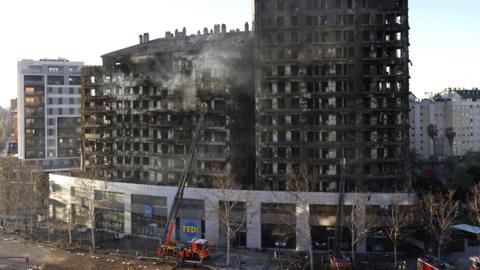 The blackened shell of the tower blocks that were set on fire in Valencia, pictured the day after the blaze