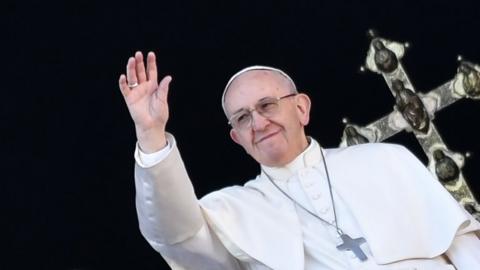 Pope Francis waves from the balcony of St Peter"s Basilica during the traditional "Urbi et Orbi" Christmas message to the city and the world, on December 25, 2017 at St Peter"s square in Vatica