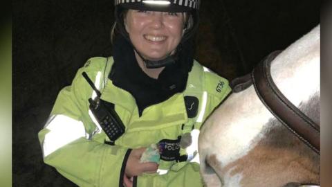 Police officer with horse and budgie