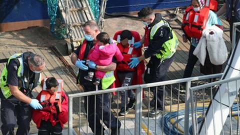 Children being brought ashore