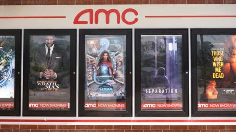 Movie posters outside of an AMC cinema