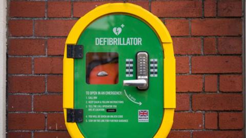 An defibrillator fixed to a wall at a shopping centre in Cardiff