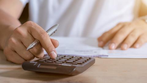 Woman using calculator