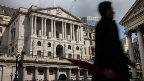 Man walks in front of Bank of England building