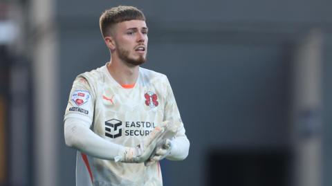 Josh Keeley rubs his palms together during a game for Leyton Orient
