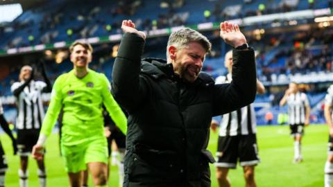 St Mirren manager Stephen Robinson celebrates with fans after a win at Ibrox