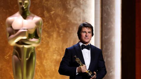 Tom Cruise wears a tuxedo and poses with his honorary Oscar during the Academy of Motion Picture Arts and Sciences 16th Governors Awards in Los Angeles on 16 November.
